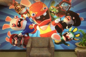 Wall mural of video game promotional art inside of a waiting room.